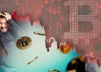 persona desesperada con gráficos en rojo y bitcoin
