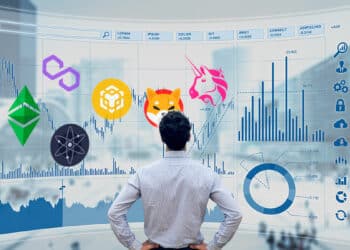 Persona mirando chart de mercado con distintos logos de criptomonedas