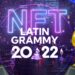premios del Latin Grammy en frente de plataforma digital con nombre del evento y nft en el fondo