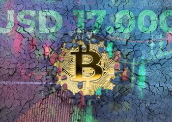 moneda de bitcoin rompiendo pared con gráfico de precio marcando usd 17.000