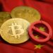 signo d prohibicion agrietado sobre apoyado en monedas de bitcoin colocadas sobre bandera de china