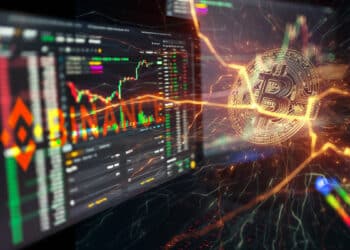 moneda de bitcoin apareciendo entre relampagos junto a pantallas de computadoras con graficos de mercado de exchange en el fondo