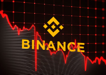 Logo de Binance y gráfico en caída.