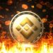 moneda de BNB de Binance entre llamas con monedas cayendo en el fondo
