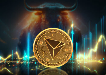 moneda de tron entre graficos de precio con toro en el fondo