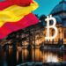 Edificio con la B de Bitcoin y bandera de España.
