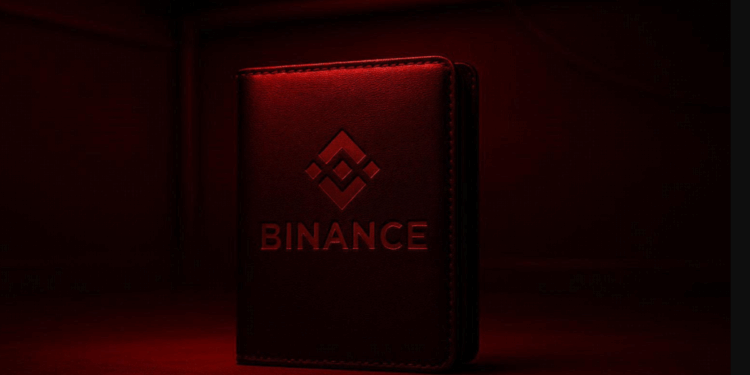 Una wallet de Binance iluminada por una luz roja, como de habitacion de revelacion de fotos .