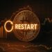 Moneda física de bitcoin dorada con la palabra "restart" y gráficas en el fondo.