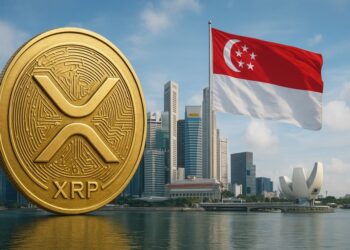 Una moneda dorada de XRP, detrás se aprecian rascacielos junto a la bandera roja y blanca de Singapur.