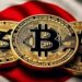 Tres monedas físicas de bitcoin doradas sobre una bandera de Japón.